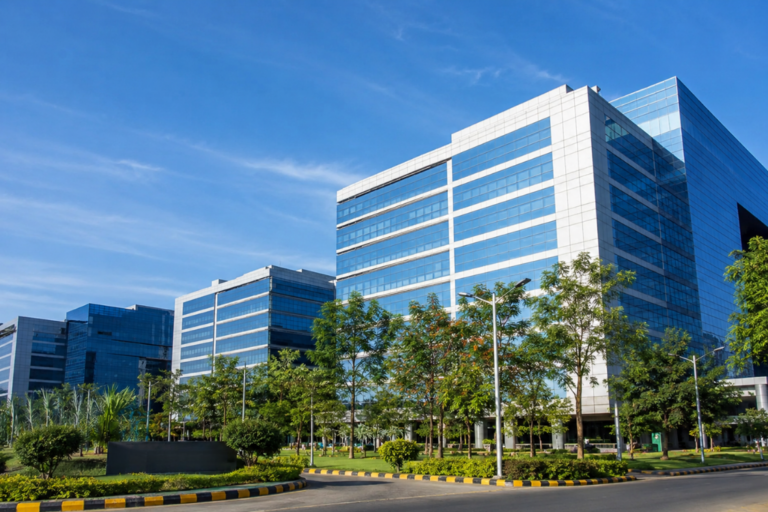 Three large industrial ventilation fans mounted on a rooftop with residential buildings in the background.